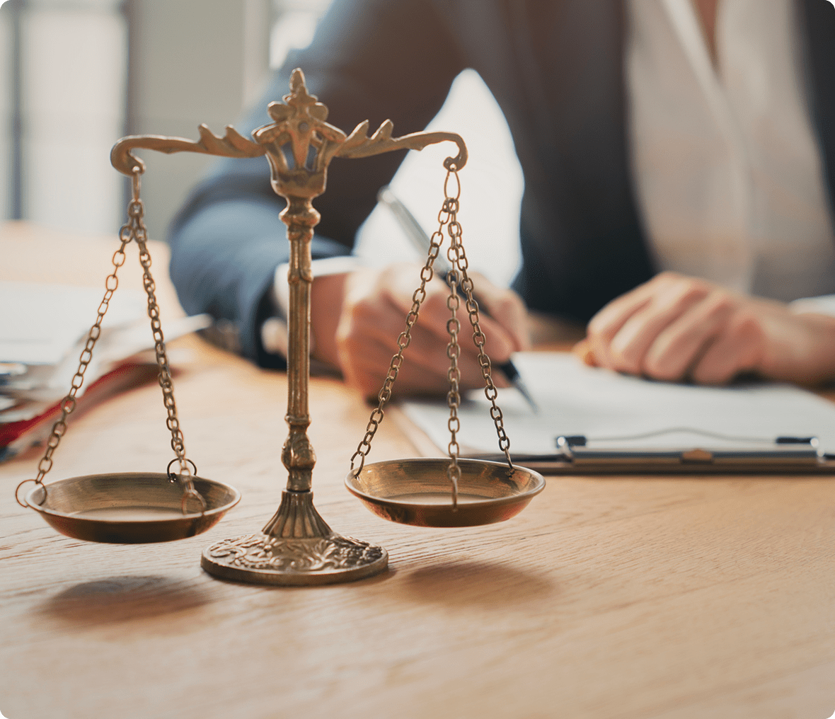 Brass scales of justice on lawyer's desk