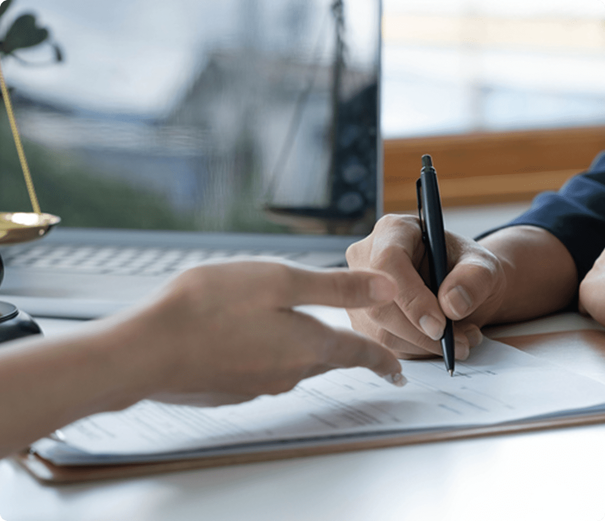 Hands writing on a contract